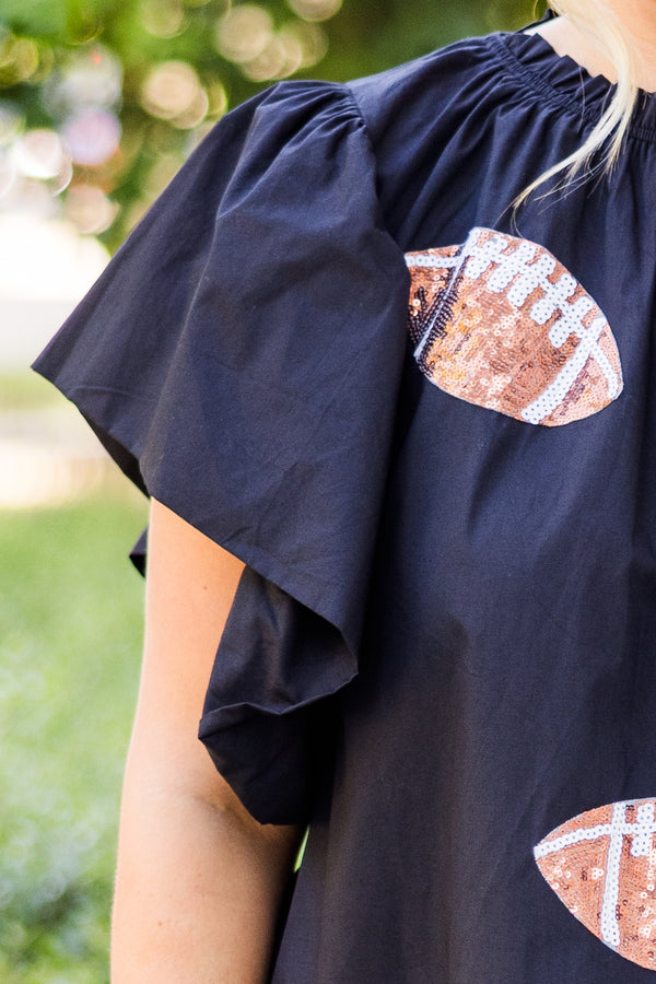  Chic Soul plus size clothing, short-flutter-sleeve black top with smocked neckline and brown sequin football patches scattered across top 