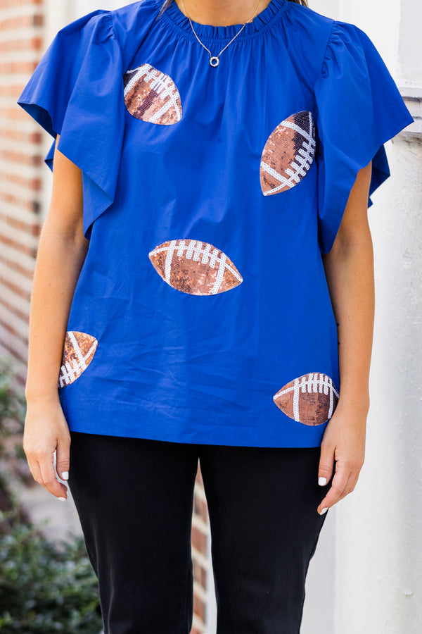 Chic Soul plus size clothing, short-flutter-sleeve blue top with smocked neckline and brown sequined football patches scattered across top 