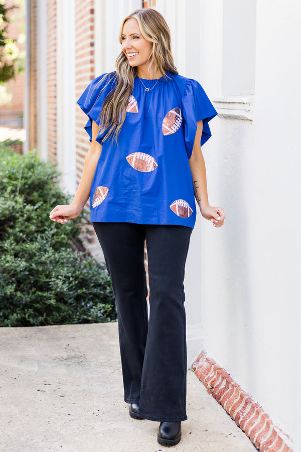 Chic Soul plus size clothing, short-flutter-sleeve blue top with smocked neckline and brown sequined football patches scattered across top 