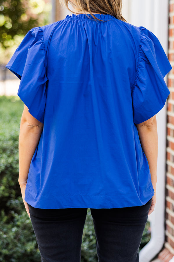Chic Soul plus size clothing, short-flutter-sleeve blue top with smocked neckline and brown sequined football patches scattered across top 