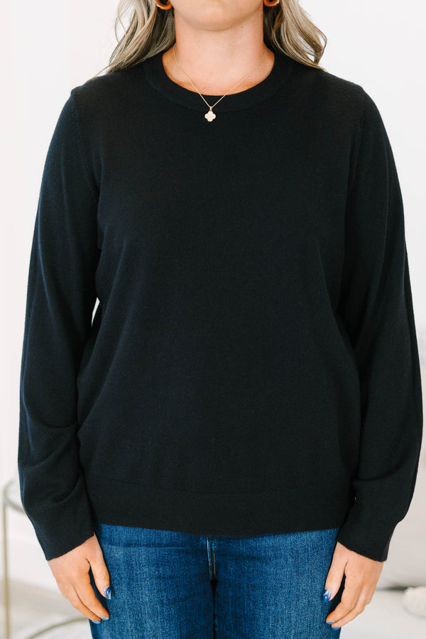 Plus size black sweater with a soft knit crewneck and relaxed, flowy fit.