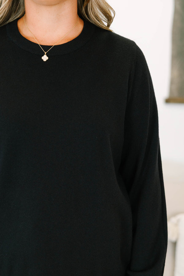 Plus size black sweater with a soft knit crewneck and relaxed, flowy fit.
