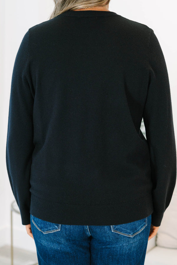 Plus size black sweater with a soft knit crewneck and relaxed, flowy fit.