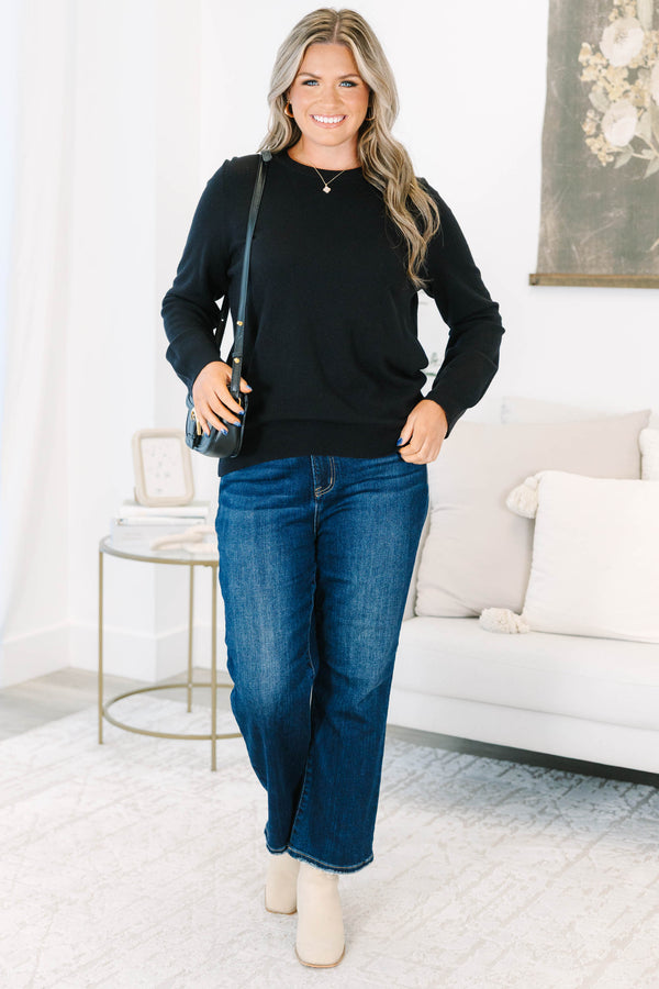 Plus size black sweater with a soft knit crewneck and relaxed, flowy fit.