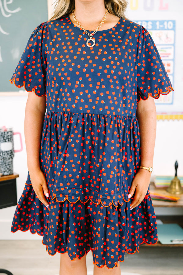 Plus Size navy dress with red apple print, tiered skirt, and scalloped red piping on sleeves.