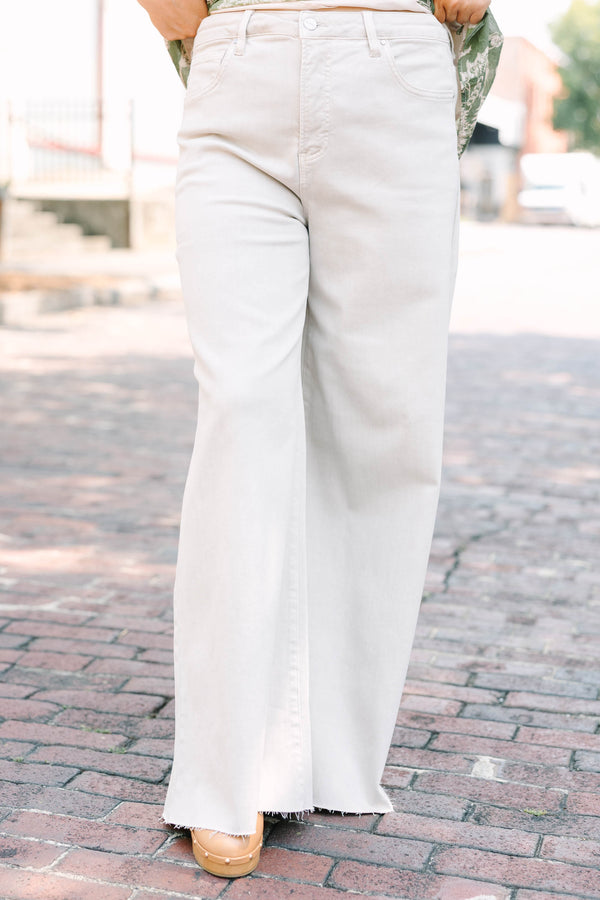 Plus Size almond-colored wide-leg jeans with a high-waist fit and raw-edge hem.