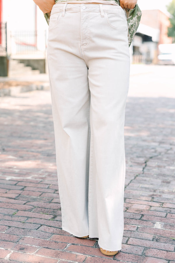 Plus Size almond-colored wide-leg jeans with a high-waist fit and raw-edge hem.