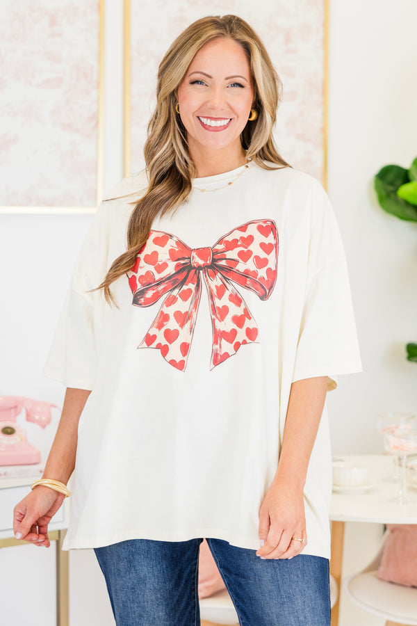 Chic Soul plus size clothing, short-sleeve ivory white boyfriend tee with a scoop-neckline and graphic art of a bow with a red heart pattern