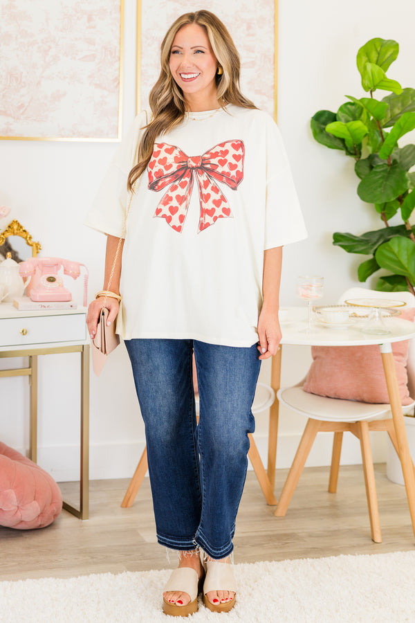 Chic Soul plus size clothing, short-sleeve ivory white boyfriend tee with a scoop-neckline and graphic art of a bow with a red heart pattern