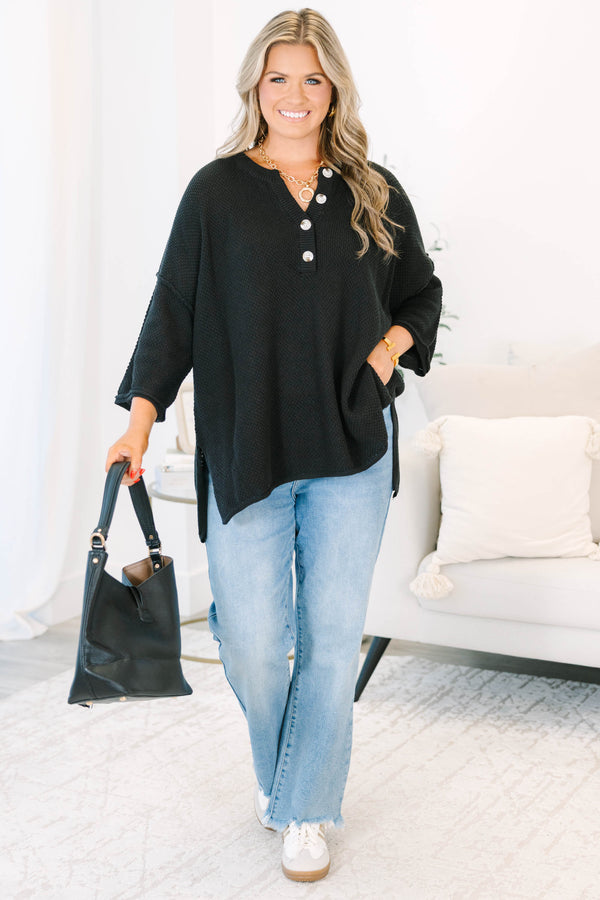 Plus Size black oversized knit top with a button-up henley neckline and three-quarter sleeves.