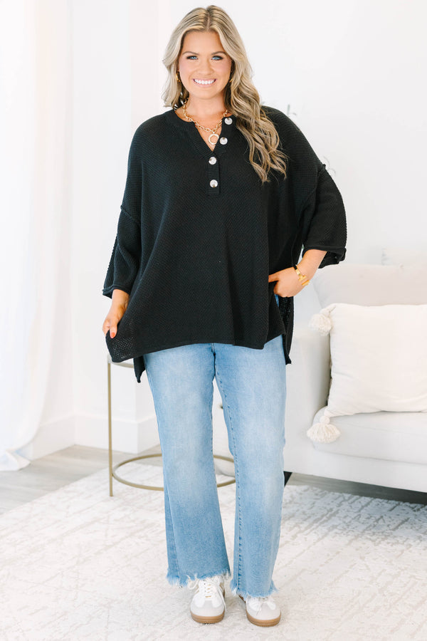 Plus Size black oversized knit top with a button-up henley neckline and three-quarter sleeves.