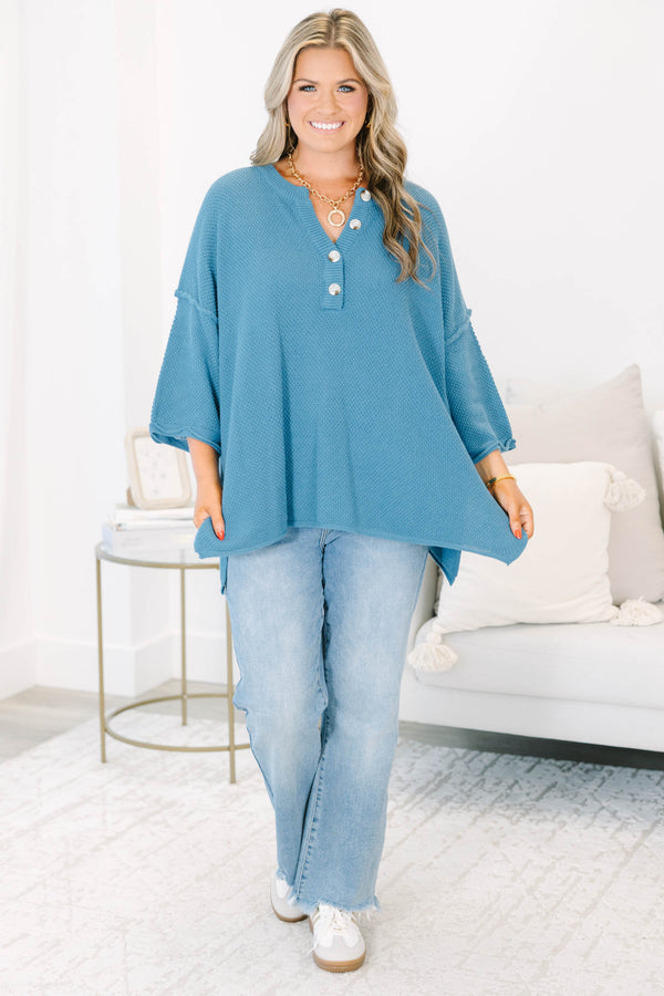 Plus Size blue knitted henley top with a relaxed fit, button neckline, and side slits.