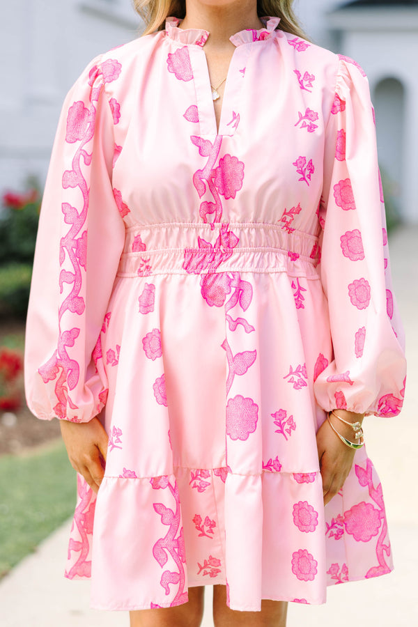 Plus Size pink floral mini dress with long puff sleeves, a smocked waist, and a ruffled hem.