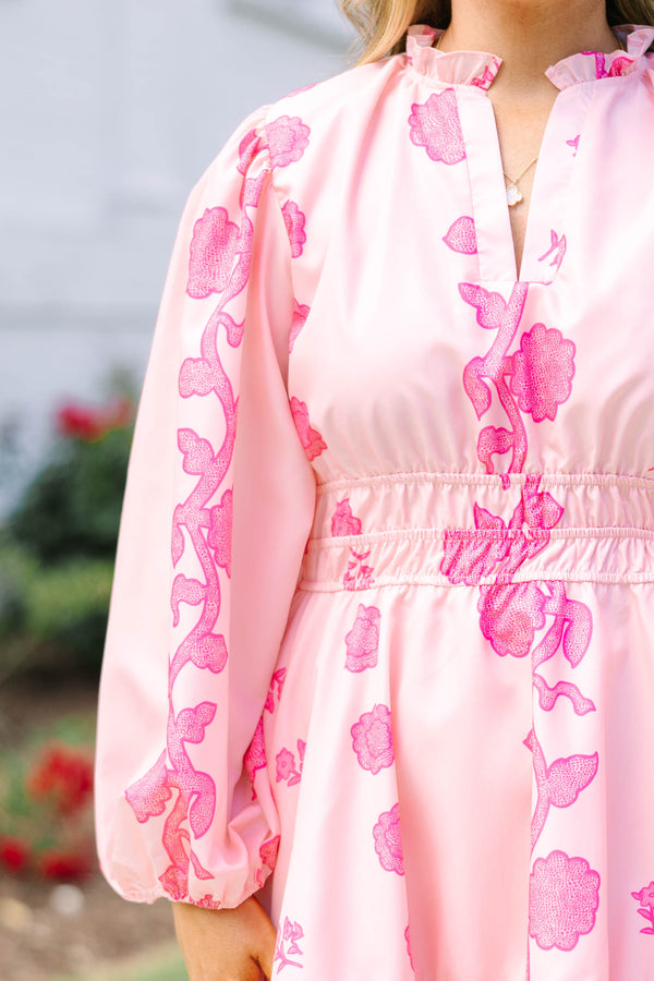 Plus Size pink floral mini dress with long puff sleeves, a smocked waist, and a ruffled hem.