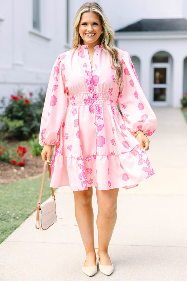 Plus Size pink floral mini dress with long puff sleeves, a smocked waist, and a ruffled hem.