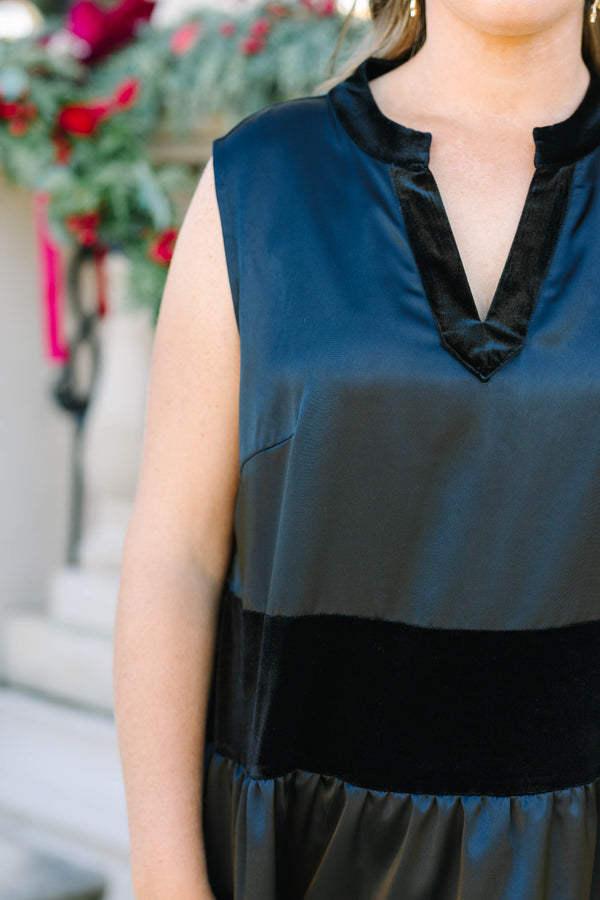 Plus size black sleeveless dress with a flowy tiered silhouette and velvet stripe details.