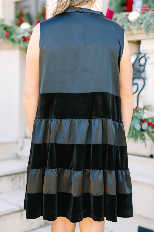 Plus size black sleeveless dress with a flowy tiered silhouette and velvet stripe details.