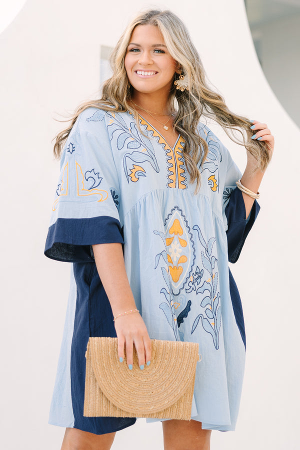 Chic Soul plus size clothing, light blue v neck tunic dress with orange and navy embroidery detailing and navy blocking on the edge of the sleeve and sides of the dress