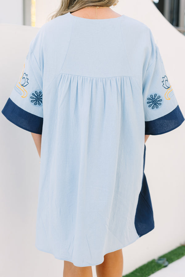 Chic Soul plus size clothing, light blue v neck tunic dress with orange and navy embroidery detailing and navy blocking on the edge of the sleeve and sides of the dress