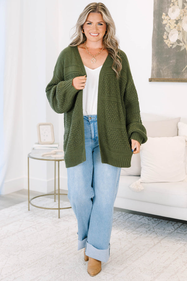 Plus size light wash high-rise wide-leg jeans featuring oversized cuffed hems and patch pockets.