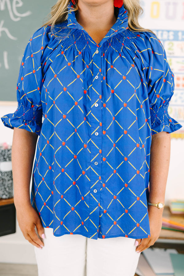 Plus Size navy top with a yellow pencil and red apple grid pattern, smocked neck, and puff sleeves.