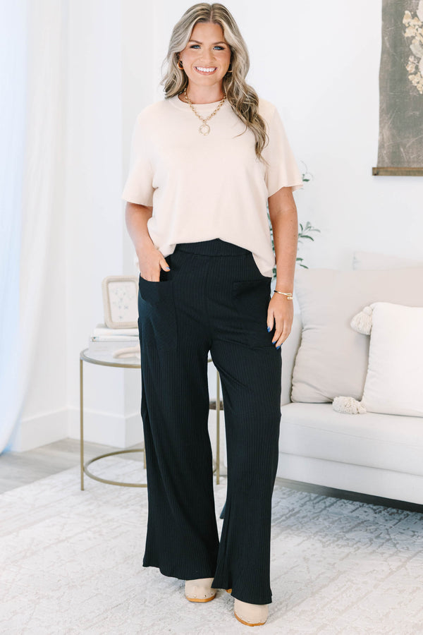 Plus Size black wide-leg ribbed knit pants with an elastic waistband and front patch pockets.