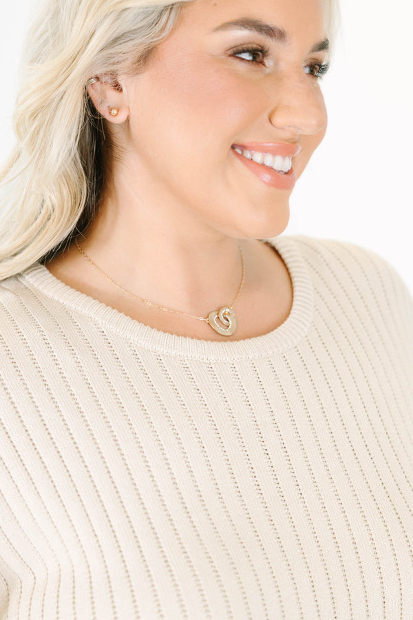 gold intertwined necklace with crystal pavé loops on a delicate chain.