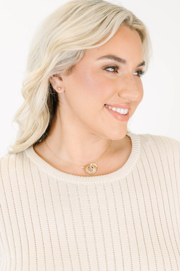  gold intertwined necklace with crystal pavé loops on a delicate chain.