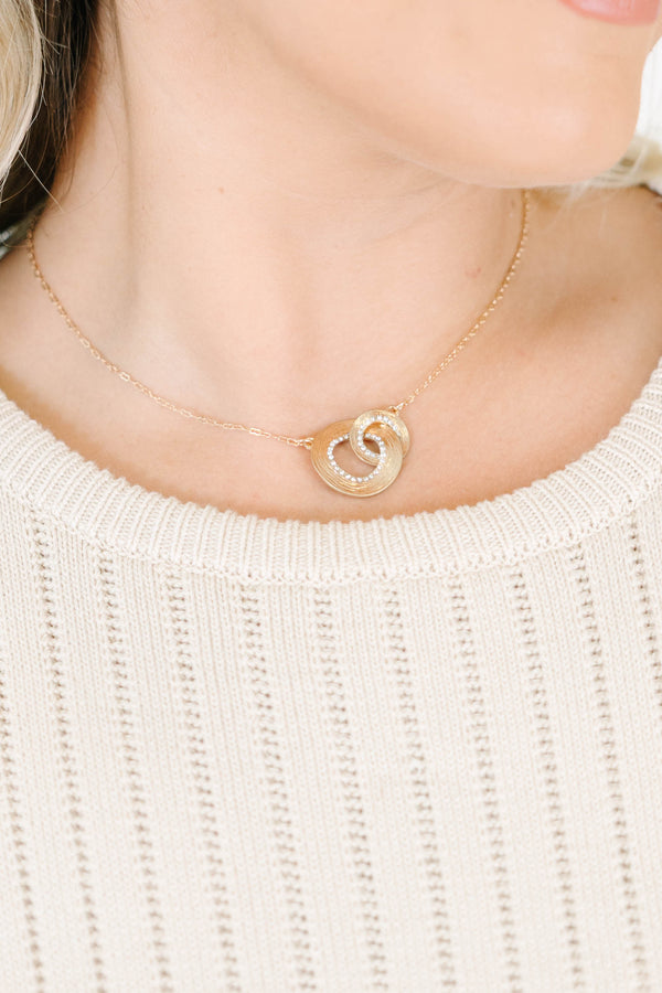  gold intertwined necklace with crystal pavé loops on a delicate chain.