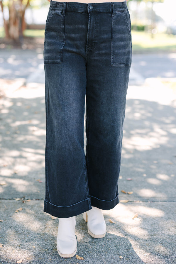 Plus Size black wide-leg jeggings with front patch pockets and cuffed hems.