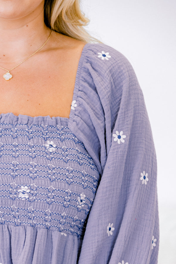 Chic Soul plus size clothing, dusty purple top with long sleeves that have a ruffle detail at the end of each sleeve and a white floral pattern throughout 