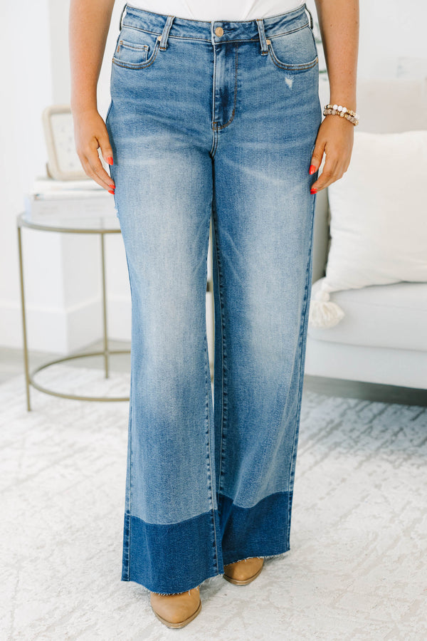 Plus Size high-waisted wide leg jeans in a medium wash with a dark wash blocked raw hem.