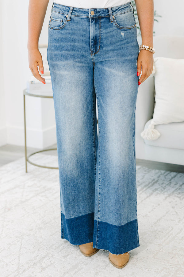 Plus Size high-waisted wide leg jeans in a medium wash with a dark wash blocked raw hem.