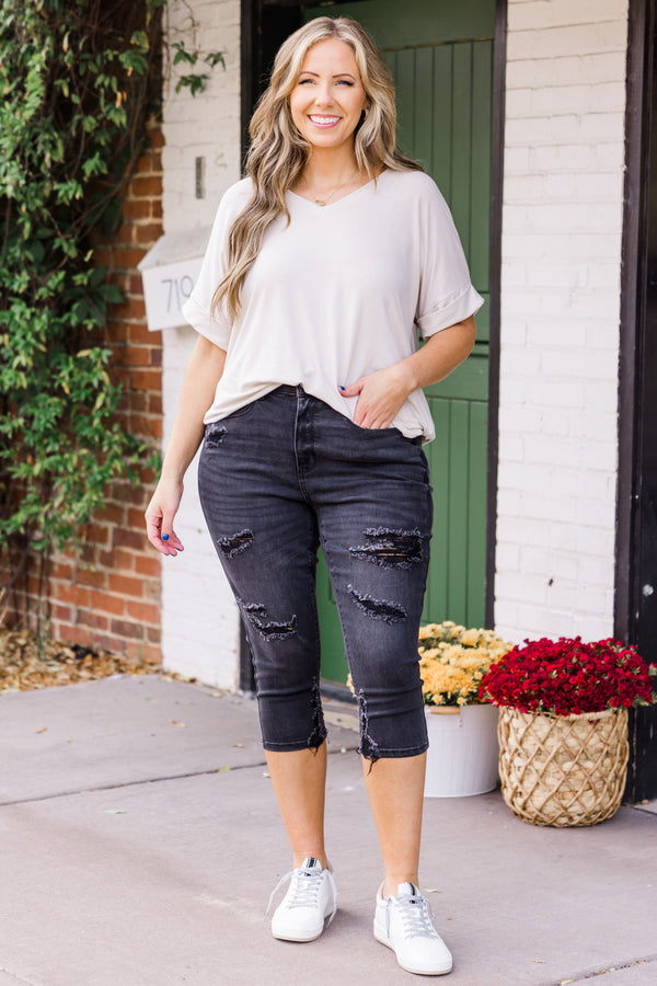 Chic Soul plus size clothing, mid-waisted black capris pants with silver button and distressed detailing 
