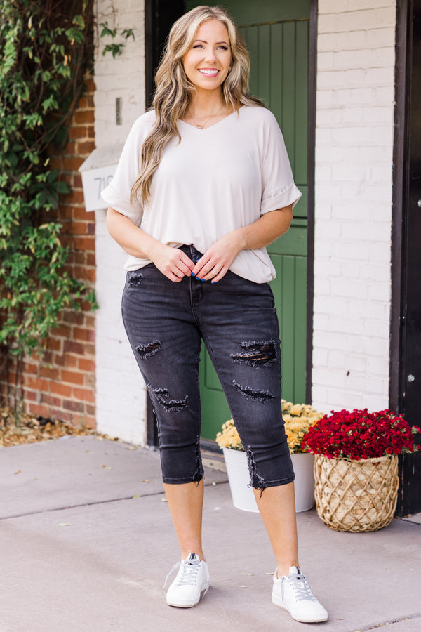 Chic Soul plus size clothing, mid-waisted black capris pants with silver button and distressed detailing 