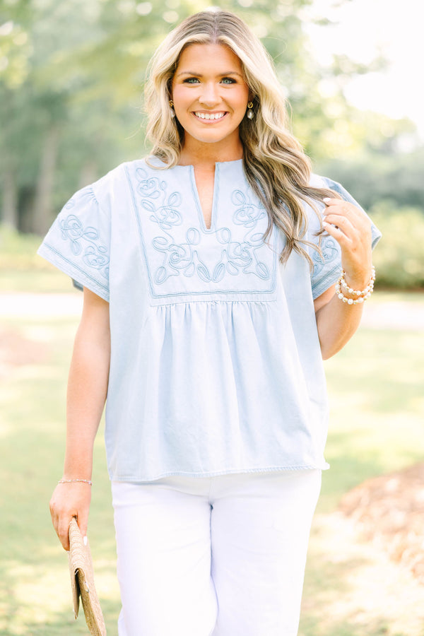 Plus Size light denim top with floral embroidery, split neckline, and short flutter sleeves.