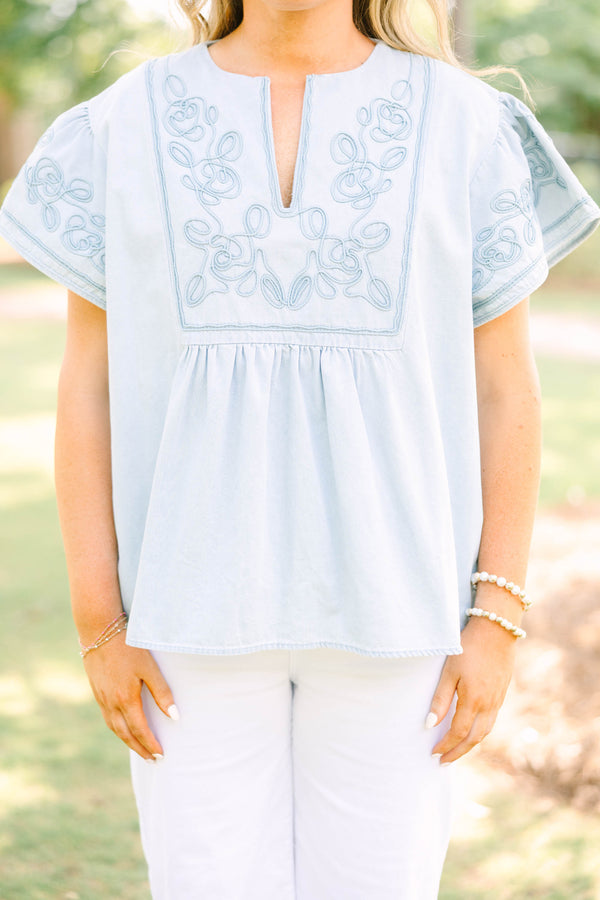 Plus Size light denim top with floral embroidery, split neckline, and short flutter sleeves.