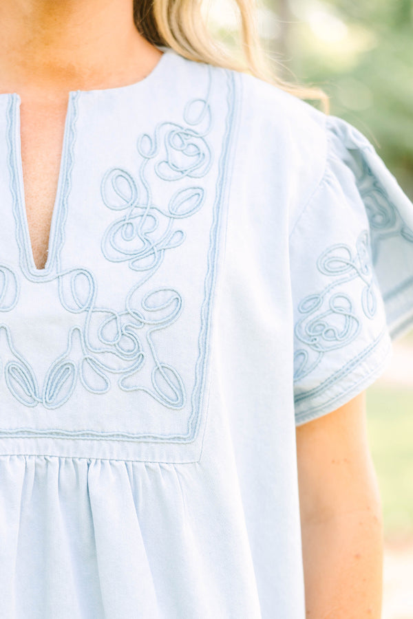 Plus Size light denim top with floral embroidery, split neckline, and short flutter sleeves.