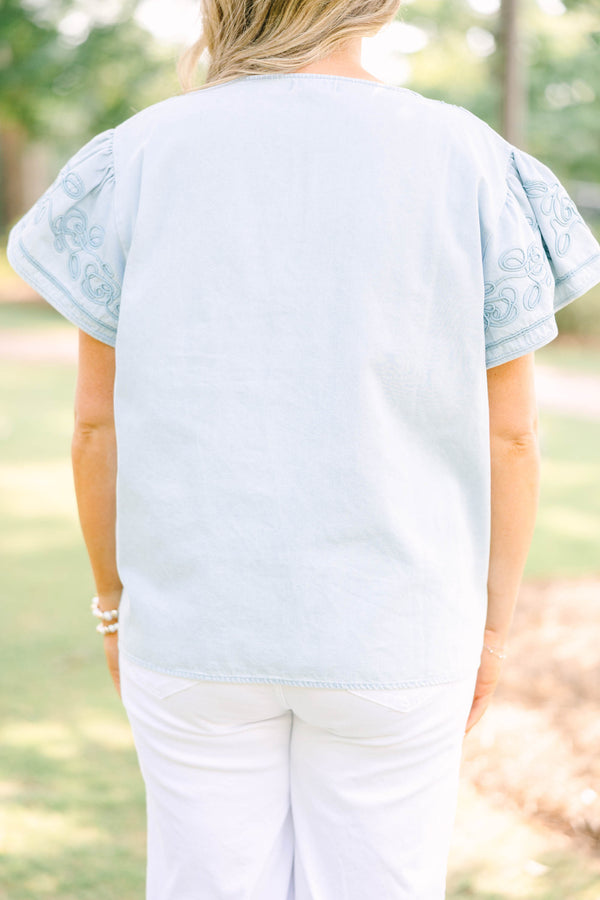 Plus Size light denim top with floral embroidery, split neckline, and short flutter sleeves.