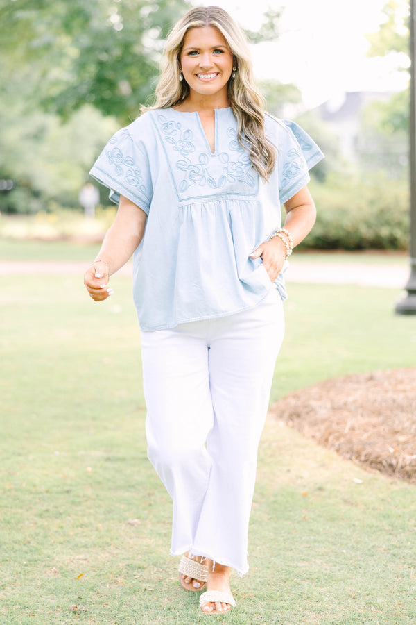 Plus Size light denim top with floral embroidery, split neckline, and short flutter sleeves.