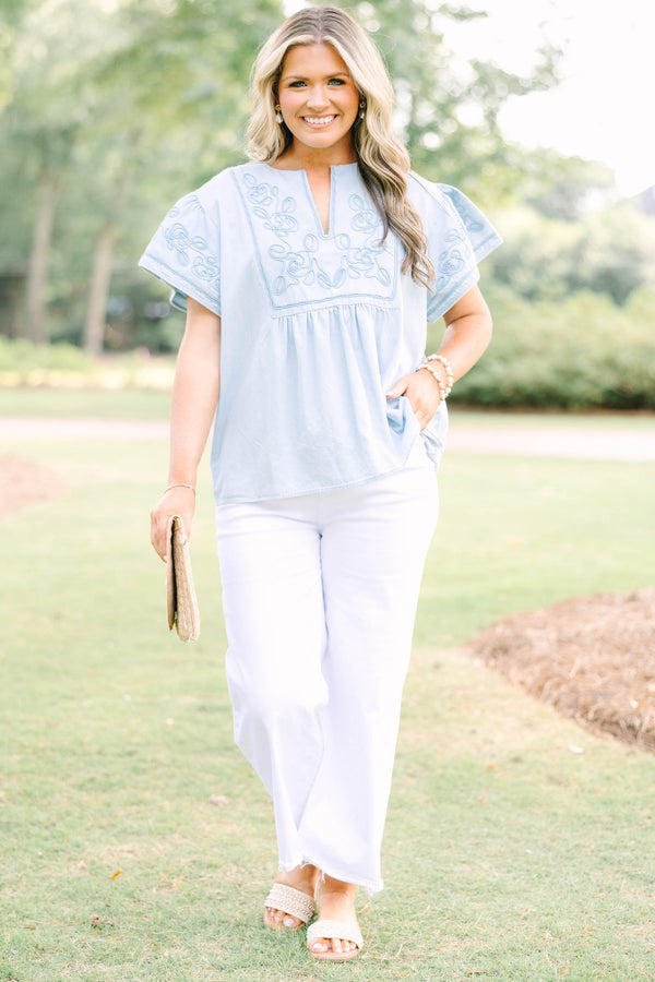 Plus Size light denim top with floral embroidery, split neckline, and short flutter sleeves.