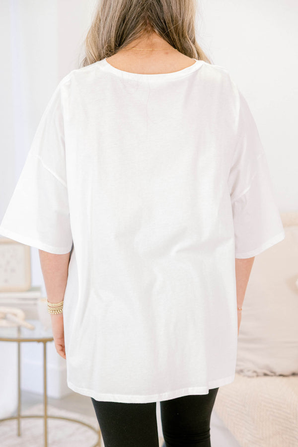 Chic Soul plus size clothing, oversized white boyfriend tee with “Just One More Chapter” written in light blue block font across the chest with book graphics