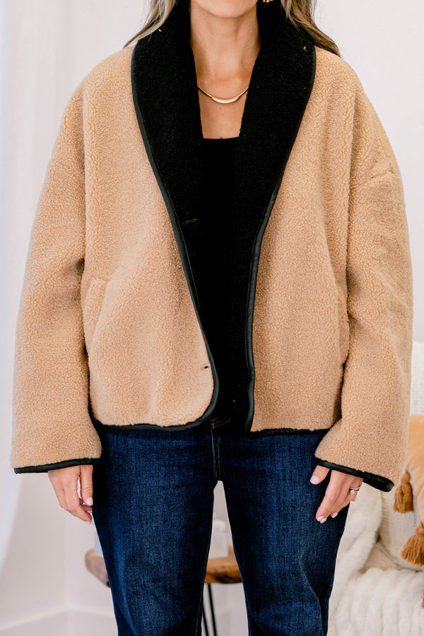 Chic Soul plus size clothing, camel fur colored jacket that has black details going around the ends of each sleeve and on the bottom of the jacket as well as button details going down the left side of the jacket 