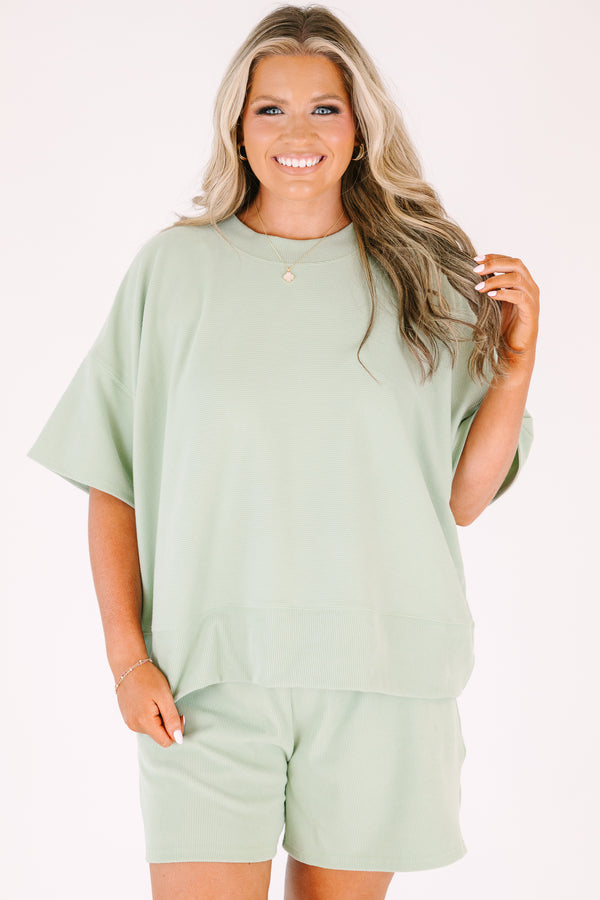 Plus Size sage green two-piece set with a short-sleeve ribbed top and matching pull-on shorts.