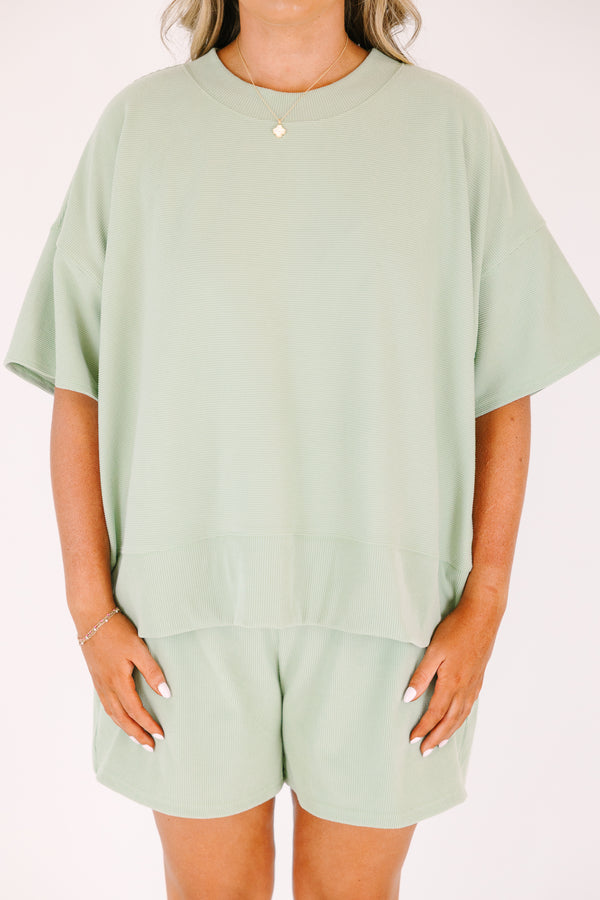 Plus Size sage green two-piece set with a short-sleeve ribbed top and matching pull-on shorts.
