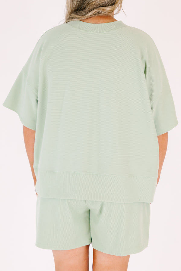 Plus Size sage green two-piece set with a short-sleeve ribbed top and matching pull-on shorts.