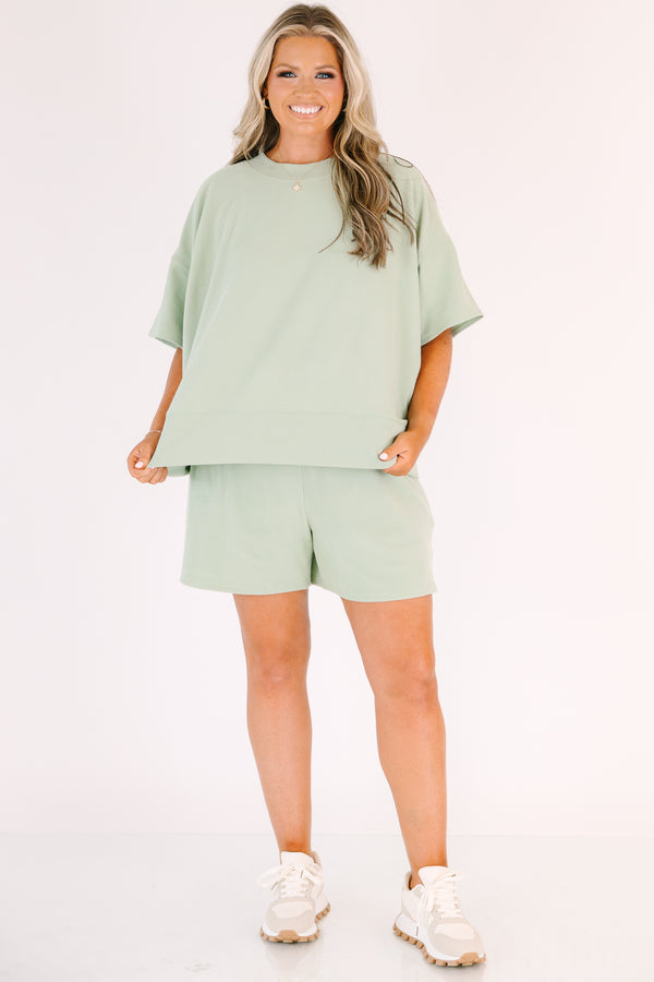 Plus Size sage green two-piece set with a short-sleeve ribbed top and matching pull-on shorts.