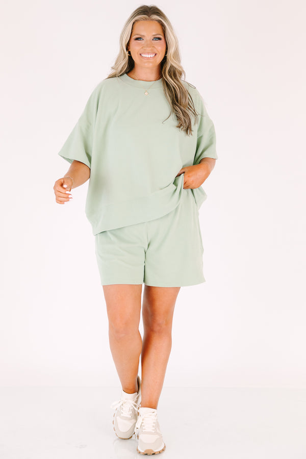 Plus Size sage green two-piece set with a short-sleeve ribbed top and matching pull-on shorts.