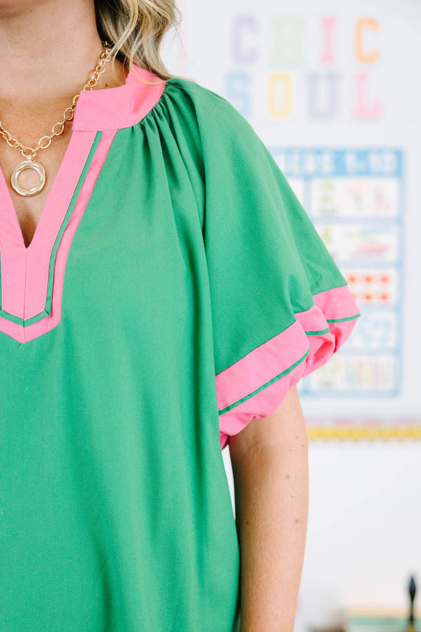 Plus size Kelly Green Dress with pink trim, split v-neck, and flowy silhouette.
