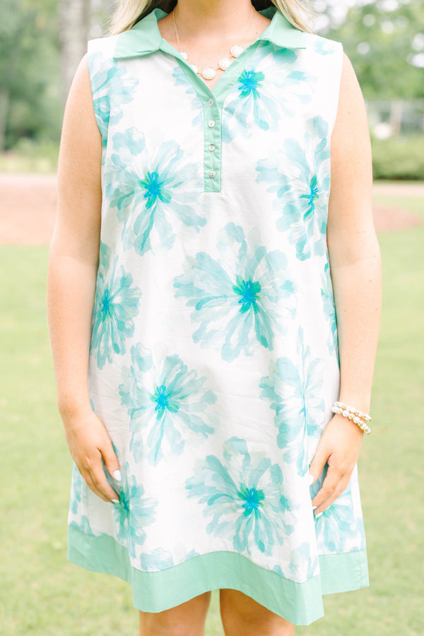 Plus Size sleeveless white dress with green floral print, a collared neckline, and button placket.